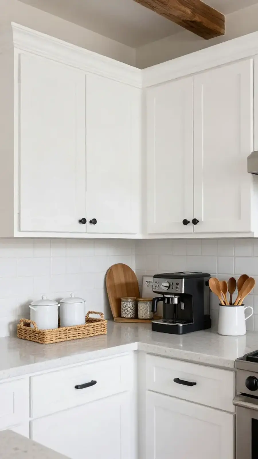 A clean and organized white kitchen corner decorated in modern farmhouse style with a coffee station and woven storage baskets.